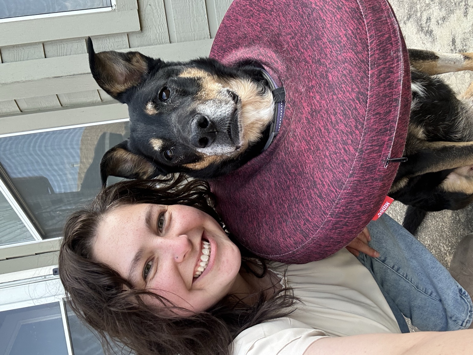 Katey with Peyton, who is wearing a recovery cone